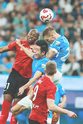 ◎四月十五日,長春亞泰隊球員蘇祖(左上)與深圳新鵬城隊球員杜加利奇爭頂。中國足球協會超級聯賽第七輪比賽中,深圳新鵬城隊主場三比一戰勝長春亞泰隊。(新華社發 彭志剛 攝)