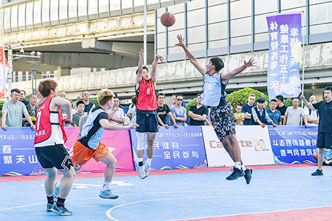 ◎ 新疆烏魯木齊,「天山杯」烏魯木齊市天山區3V3街頭籃球聯賽首月冠軍爭奪戰日前開賽。賽事吸引眾多籃球愛好者同台競技,不少市民到場觀賽助威。圖為比賽現場。(中新社發 金奇攝)